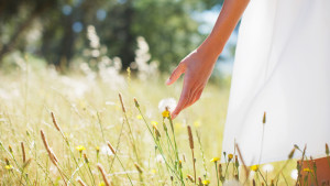 C2W9E5 Woman walking through field. Image shot 2010. Exact date unknown.